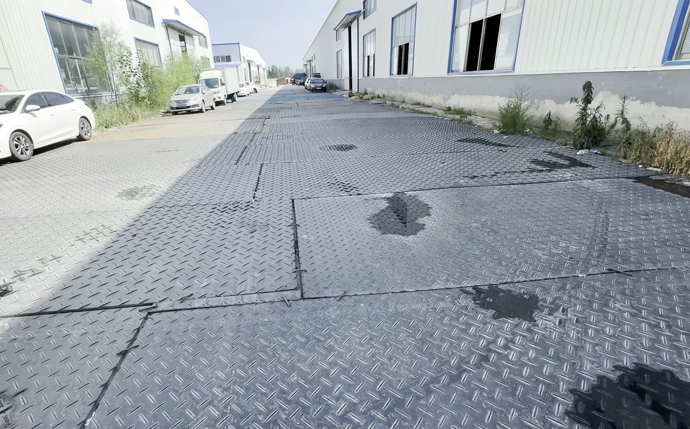 Ground protection mats laid between factory buildings