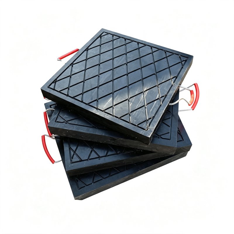 Stack of black UHMWPE crane outrigger pads with rope handles